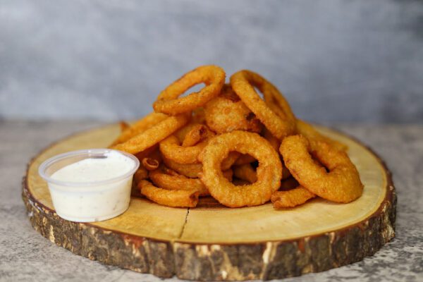 Onion Rings with a dip on a tray