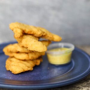 closeup shot of Chicken fingers with a dip