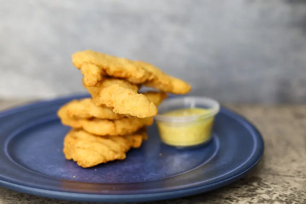 closeup shot of Chicken fingers with a dip