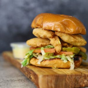 closeup shot of Chicken Tender Sandwich on a wooden platter