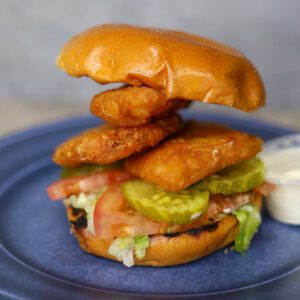 closeup of a Rockfish Sandwich with a dip