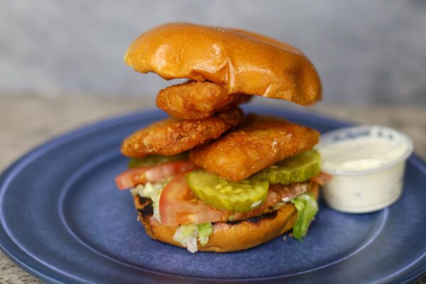 closeup of a Rockfish Sandwich with a dip