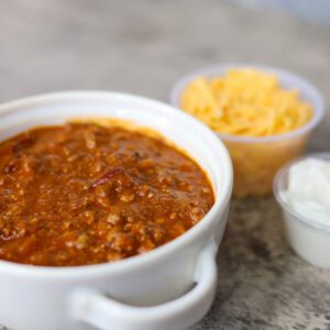 Cup of Chili sauce and two dips near it