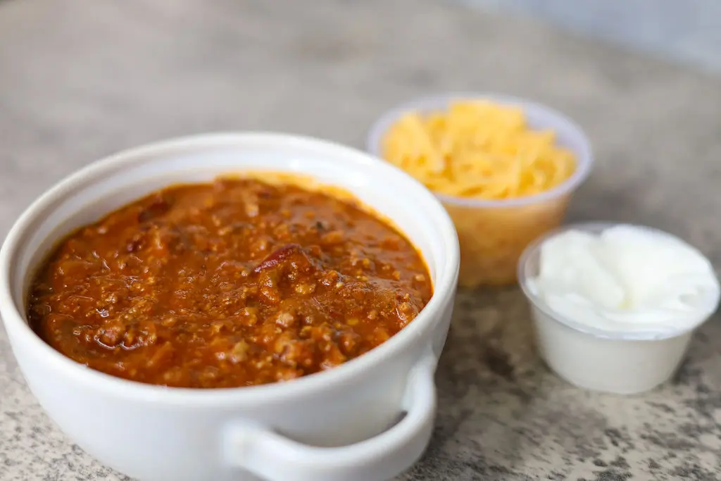 Cup of Chili sauce and two dips near it